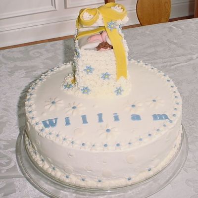 Baby "gift" Popping Out Of A White Buttercream With Fondant Blue And White Daisies Baby "gift" Popping Out Of A White Buttercream With Fondant Blue And White Daisies