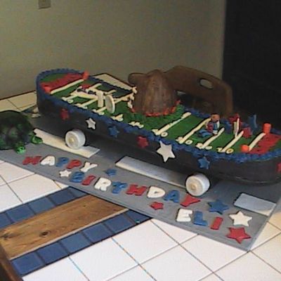 Skateboard With Football Field On The Road By A Passing Turtle Skateboard With Football Field On The Road By A Passing Turtle