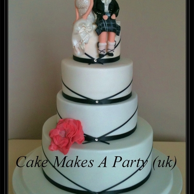 4 Tier Ribbon Cake With Bride And Groom Figurines 4 Tier Ribbon Cake With Bride And Groom Figurines