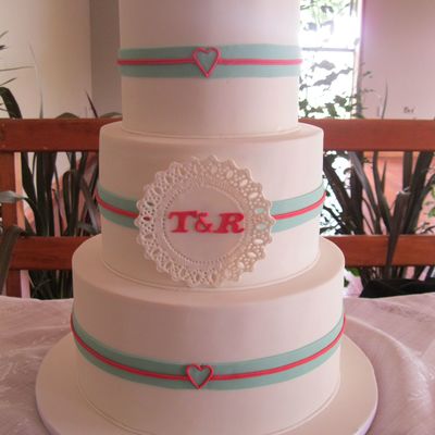 3 Tier Wedding Cake With The Design Taken From The Couples Colour Scheme And Invitations Handcut Doily And Fondant Ribbons The Hearts Wer 3 Tier Wedding Cake With The Design Taken From The Couples Colour Scheme And Invitations Handcut Doily And Fondant Ribbons The Hearts Wer