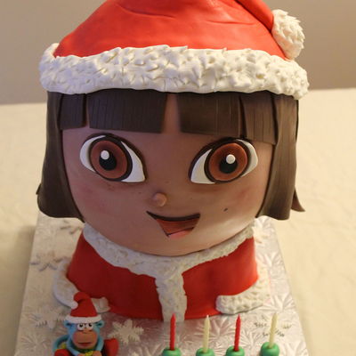 Dora Christmas Birthday Cake With Gumpaste Boots Figure Sculpted Chocolate Head And Vanilla Body Cake Filled With Vanilla Smbc Iced W Dora Christmas Birthday Cake With Gumpaste Boots Figure Sculpted Chocolate Head And Vanilla Body Cake Filled With Vanilla Smbc Iced W