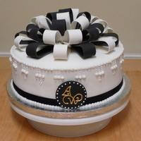 Black And White Bows An elegant black and white bow-topped cake for a friends birthday.Pastillage monogram plaque on the front and pastillage bows on top.