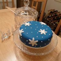 Christmas Cake Christmas cake with blue fondant and white fondant cutout snowflake pattern.