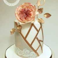18 Th Birthday Cake Doble barrel cake with marbled details and geometric design in gold rose. Gumpaste English rose on top.
