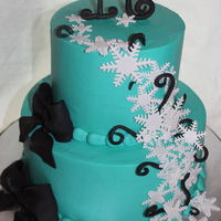 Snowflake Cake 6" top tier with a 9" bottom tier. BC icing and fondant/GP accents.Made for a Sweet 16 Birthday.