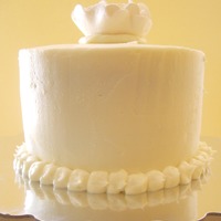 White Bridal Shower Small plain white bridal shower cake with a white gumpaste flower on top. The topper was the monogram taken from the invitation and was...