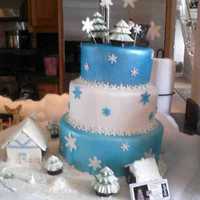 Christmas Scene 8, 10, 12, with chocolate santa sleigh. Chocolate trees. At the bottom is a christmas scene, of a chocolate house, trees and a little...