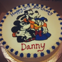 Mickey And Friends Chocolate Chip pound cake with buttercream icing. I used the piping gel transfer technique to apply the characters.