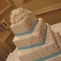 Vintage Quince 14/12//9/6 slightly offset. Fondant icing with royal scroll that was then painted with silver. Roses were hand molded. TFL!