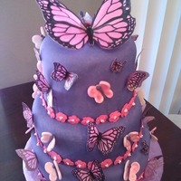 Butterfly Escape chocolate cake filled with kahlua whipped ganache, covered in satin ice fondant and accessorized with fondant and rice paper butterflies. a...