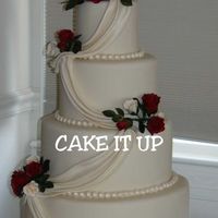 "simply Ivory" Fondant covered, w/ GP roses and pearlized drapes.
