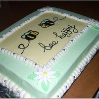 Be Happy Chocolate cake in white icing modelled after Bellissimo Bee Baby bedding