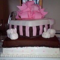 Baby Shower Cake - Stacked Boxes With Bunny Baby Booties And Bow My first stacked box cake. Cake is iced in buttercream with fondant accents. Bow, stripes, dots and lids made from fondant, baby booties...