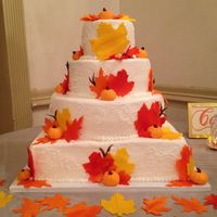 Fall Themed Wedding Cake Fall leaves and pumpkins made from fondant, cake iced in buttercream