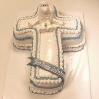 Cross W/ Lamb Not a great picture. Vanilla cake, raspberry filling, white chocolate buttercream. Fondant accents