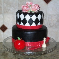 Twilight Theme Cake Twilight themed fondant covered birthday cake for a young fan. Ruffled tulips made from gum paste. Apple and ribbons made with fondant.