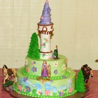 Rapunzel Cake Niece Isabel's cake. Covered in buttercream, flowers are gumpaste, trees are icecream cones covered in royal icing, tower is made of...