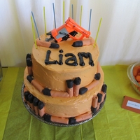 Nerf Cake Orange creamsicle cake, orange cream cheese frosting, chocolate dipped cookies for the darts