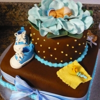 Chocolate Fondant Baby Shower Cake Chocolate Fondant covered cake - The baby is made with a First Impressions baby mold. The baby is laying in a bed of fondant pale blue rose...