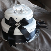 All About The Bling... A lemon cake with raspberry IMBC in the centre. Covered in fondant with black ribbon and glass diamonds to decorate