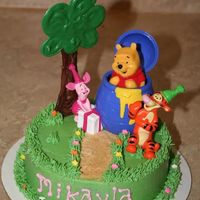 Winne The Pooh Smash Cake 6" choc cake with bc. Tree is chocolate. Winnie Pooh from Decopac. Gave me Winnie after I'd decorated that's why the fit is...