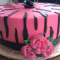 Pink Rose bc frosting, ribbon made with mmf, rose made with frosting.