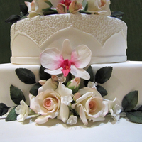 Wedding Cake All flowers - roses, orchids , leaves - are from gumpaste, dusted with dustind colours.The cakes are covered with sugarpaste.