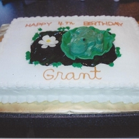 Large Frog Birthday Cake Molded candy frog on fondant lily pad with tinted piping gel for pond