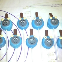 Thomas The Train Cake Pops Chocolate cake pops shaped into cylinders, fondant face, candy necklace pieces for headlights and half a tootsie roll for the steam pipe