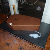 Halloween Coffin With Skeleton White Chocolate cake with fudge/caramel/pecan filling - delicious! All fondant covered, fondant rat, gumpaste skeleton hand. Candlestick...