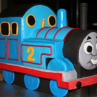 Thomas The Tank A Thomas cake for a 2nd birthday. This is all cake, except for the smoke stack and the platform, which is a cake board covered with grey...