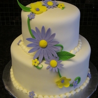 Purple And Yellow 40Th Birthday Fondant covered cake with purple and yellow gumpaste accents.