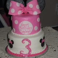 Minnie Mouse Vanilla cake frosted in buttercream with fondant and gumpaste accents.