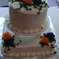 Buss.jpg Very small tier cake for a wedding reception for a couple who married in Vegas. They wanted orange and purple flowers. Buttercream...