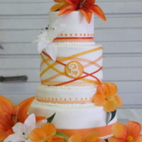Wedding Cake buttercream frosting with different ribbons in orange.