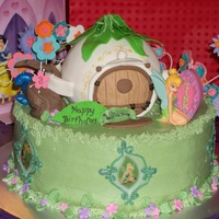 Tinkerbell And House This was my god daughter's birthday cake. She wanted Tink. I used the edible images around the cake. Teapot house was krispy treat...