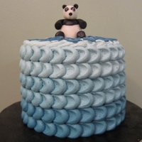 Blue Ombre Panda 2 rounds covered in buttercream using gradation effect of blues. Topped with a fondant panda.