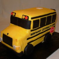 Ncc School Bus 9" X 13" cake, cut in thirds, stacked & carved into a bus shape. Buttercream coat and fondant accents. Wheels are oreos...