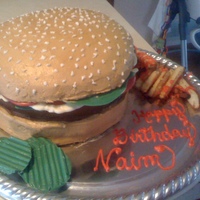 Hamburger three layers top is a pyrex bowl all buttercream pickles tomatoes and lettuce are chocolate. Fries were cut cake put under the broiler. Fun...