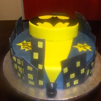 Batman Birthday Cake Bottom layer is covered in buttercream with fondant accents, top layer is covered in yellow fondant.