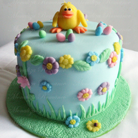 Easter Chick Fondant covered cake with modeling paste figure and flowers.The cake is only 8" long and 8" height. This will be a present to my...