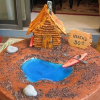 Cabin-On-The-Pond Cake Chocolate Cake with buttercream frosting. Pond is Jello; Cabin is made from pretzels and royal icing with hand-painted details. Kayak,...