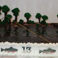 Carter's Fly Fishing 12 x 18 cake w/BC icing. I carved a bit of a dent across the middle for the depth of the water. Gum-paste figure (CelShapes - fairies mold...
