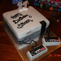 Nintendo White cake with buttercream...fondant accents ( fondant covered brownie paddles )