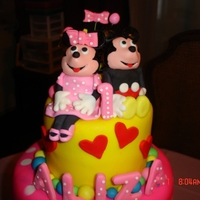 Mickey And Minnie 12"-10"-6" sour cream white and whipped white chocolate ganache top and lower tier and middle triple threat chocolate and...