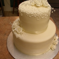 Small Wedding Cake This is a small wedding cake covered with mmf frosting. The flowers are gumpaste.