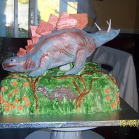 Dinosaur My first attempt at Rice Krispie Treat moulding. Bottom is chocolate cake covered in fondant. The dinosaur is covered in fondant.