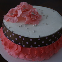Pink Buttercream icing with fondant accents. The flowers are gumpaste. Inspired by various cakes on CC.