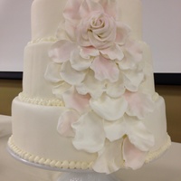 Cascading Flower Petal Cake Moist chocolate cake w. peanut buttercream filling, covered with vanilla buttercream and mm fondant. The flower petals are made with...