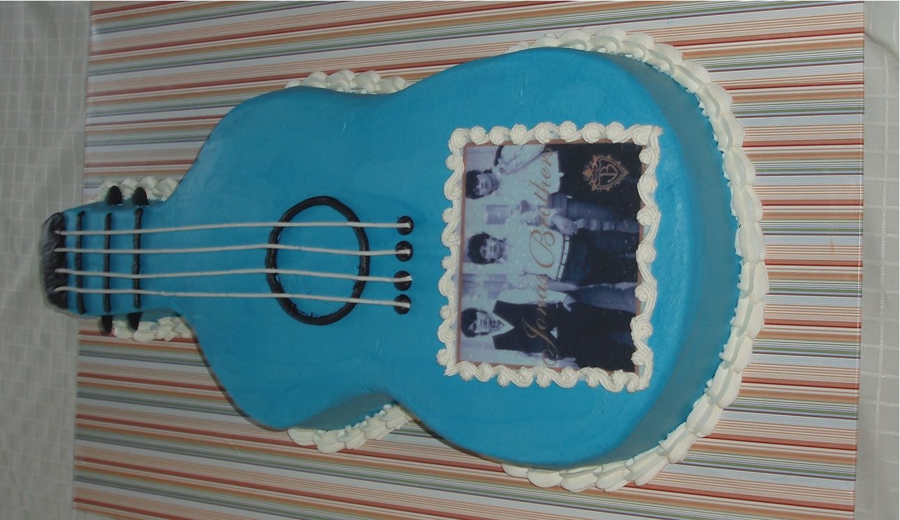 Jonas Brothers Guitar Cake Guitar Cake iced in buttercream with fondant strings and Jonas Brothers edible image